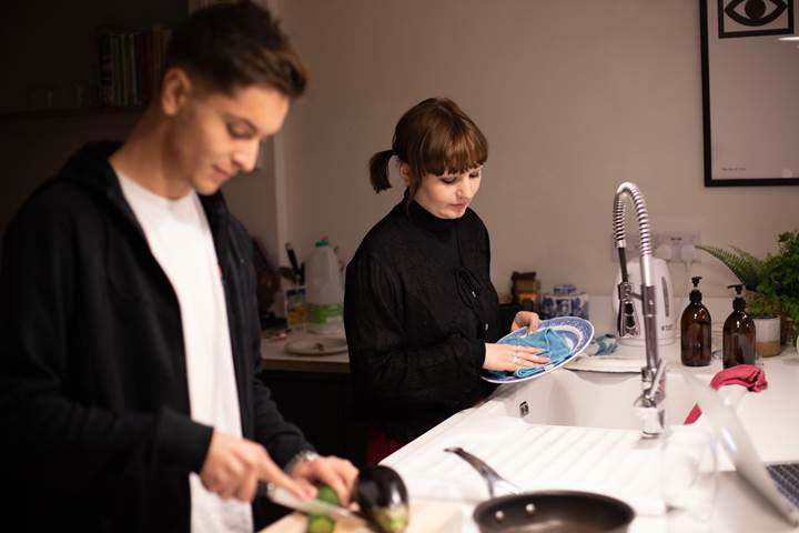 Girl Dries Dishes As Boy Chops Veg